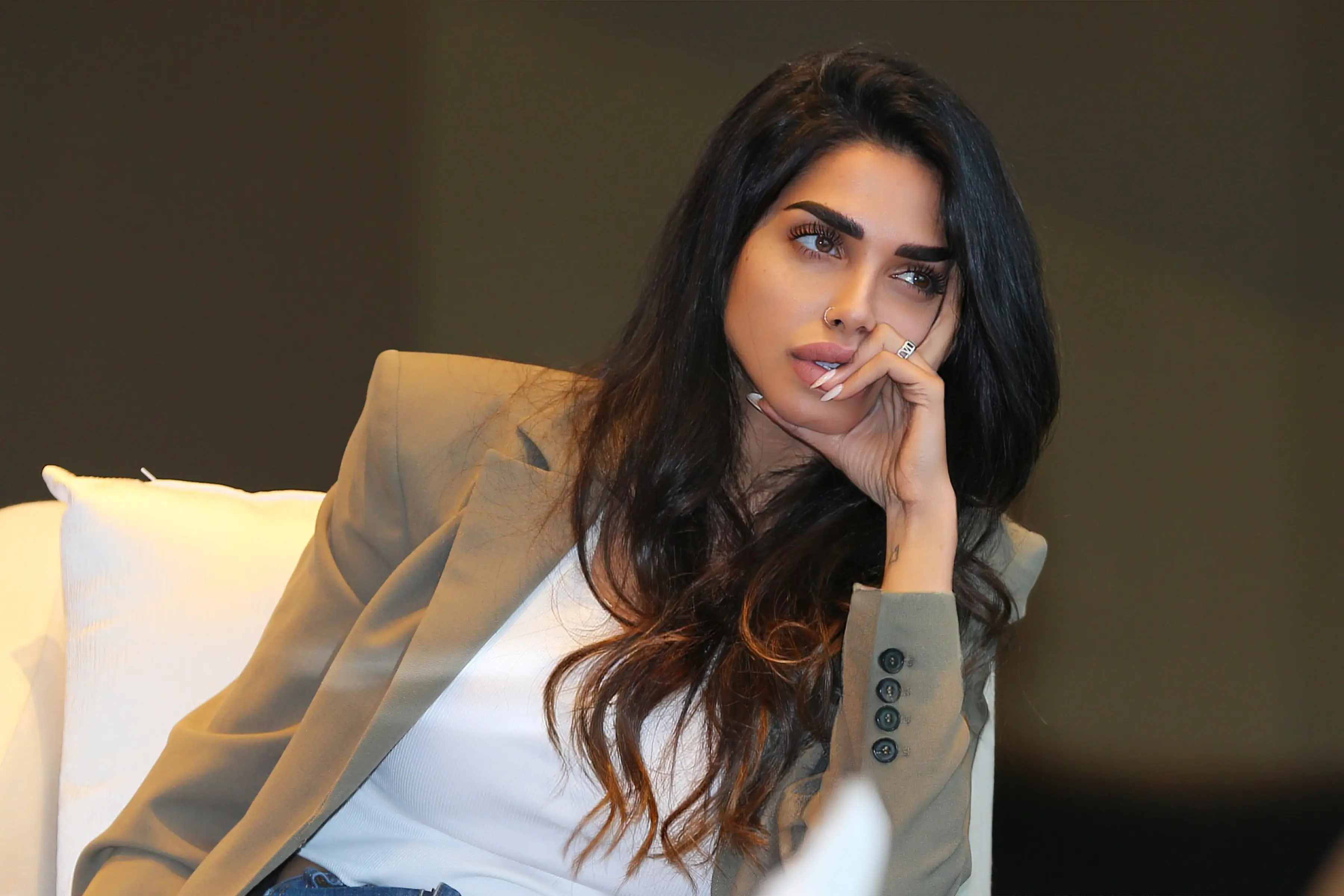Sara Al Madani seated in a blazer