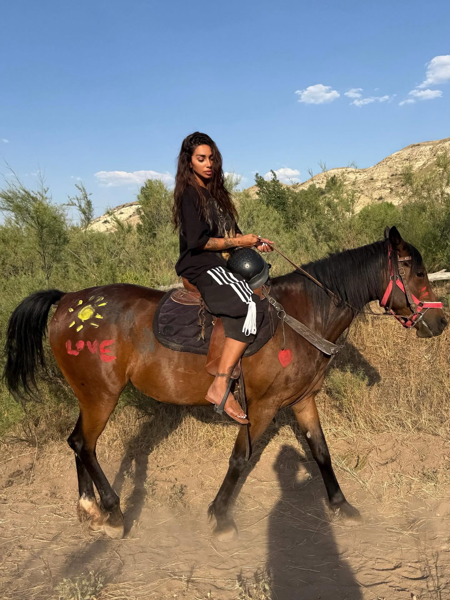Sara Al Madani riding a horse in the desert