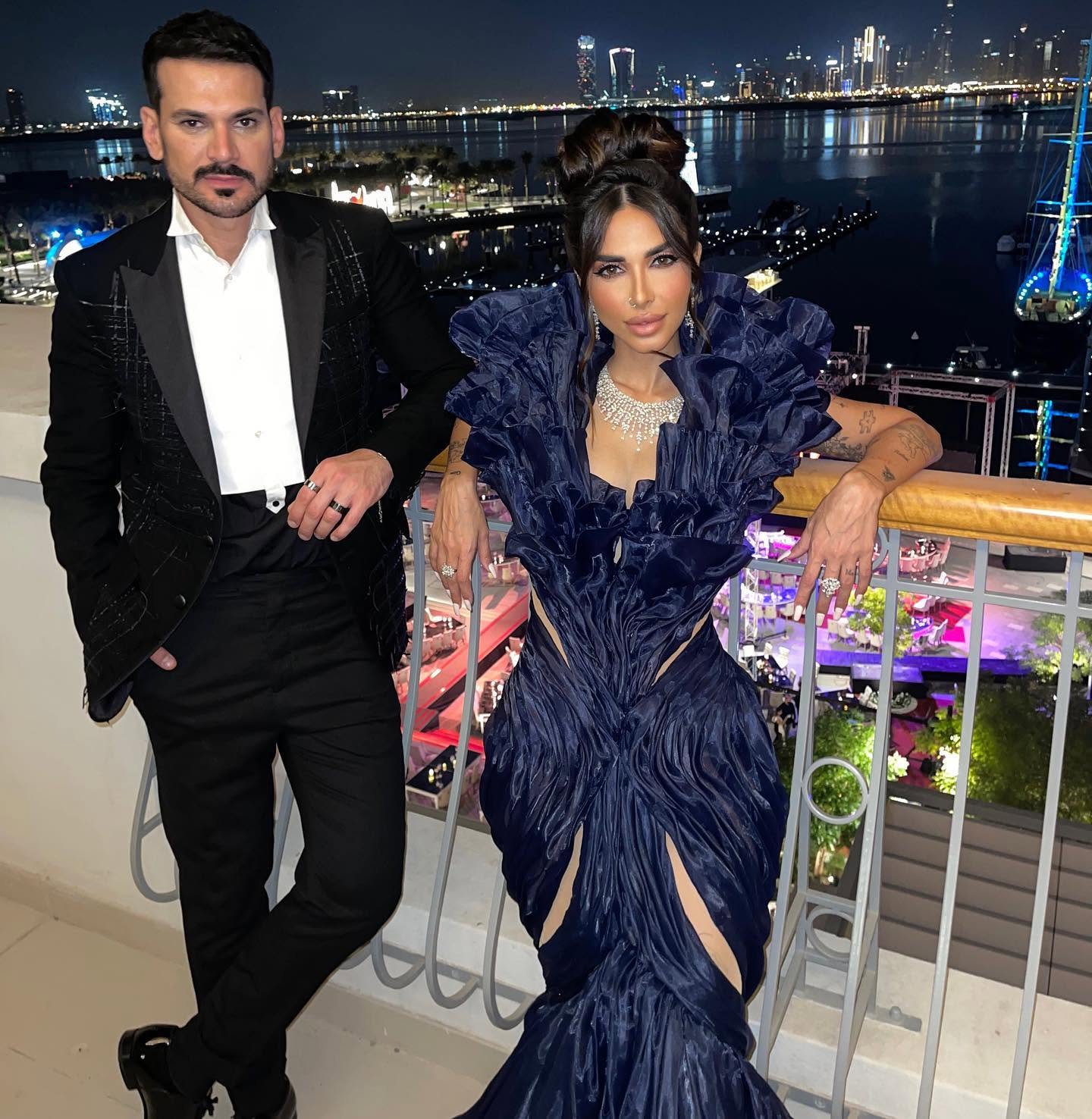 Sara Al Madani in a ruffled evening gown by the waterfront